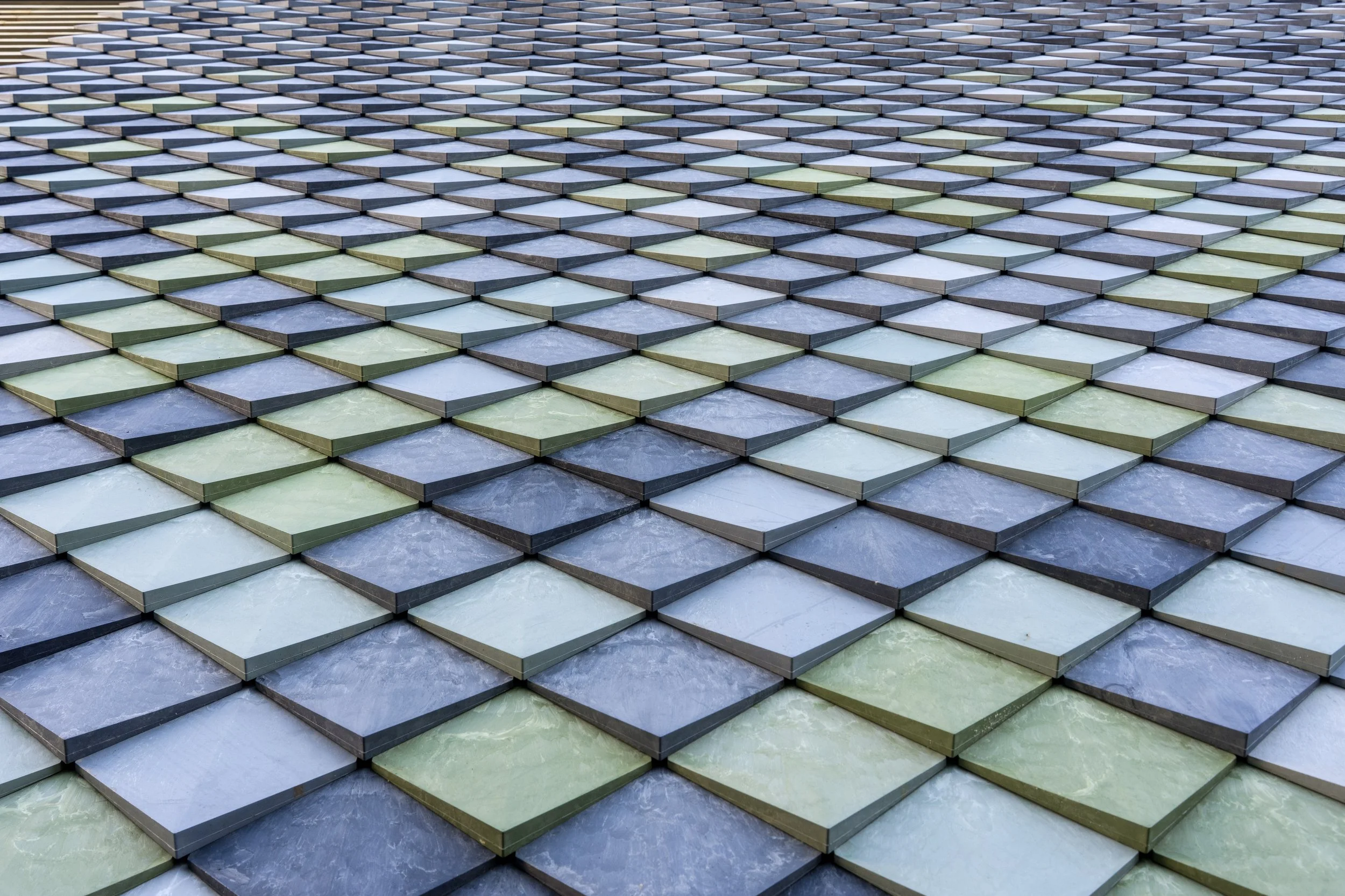 Close up of wall cladding Pretty Plastic in different shades of green and grey 