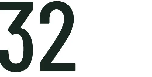 Close-up of the number 32 in black text on a white background.