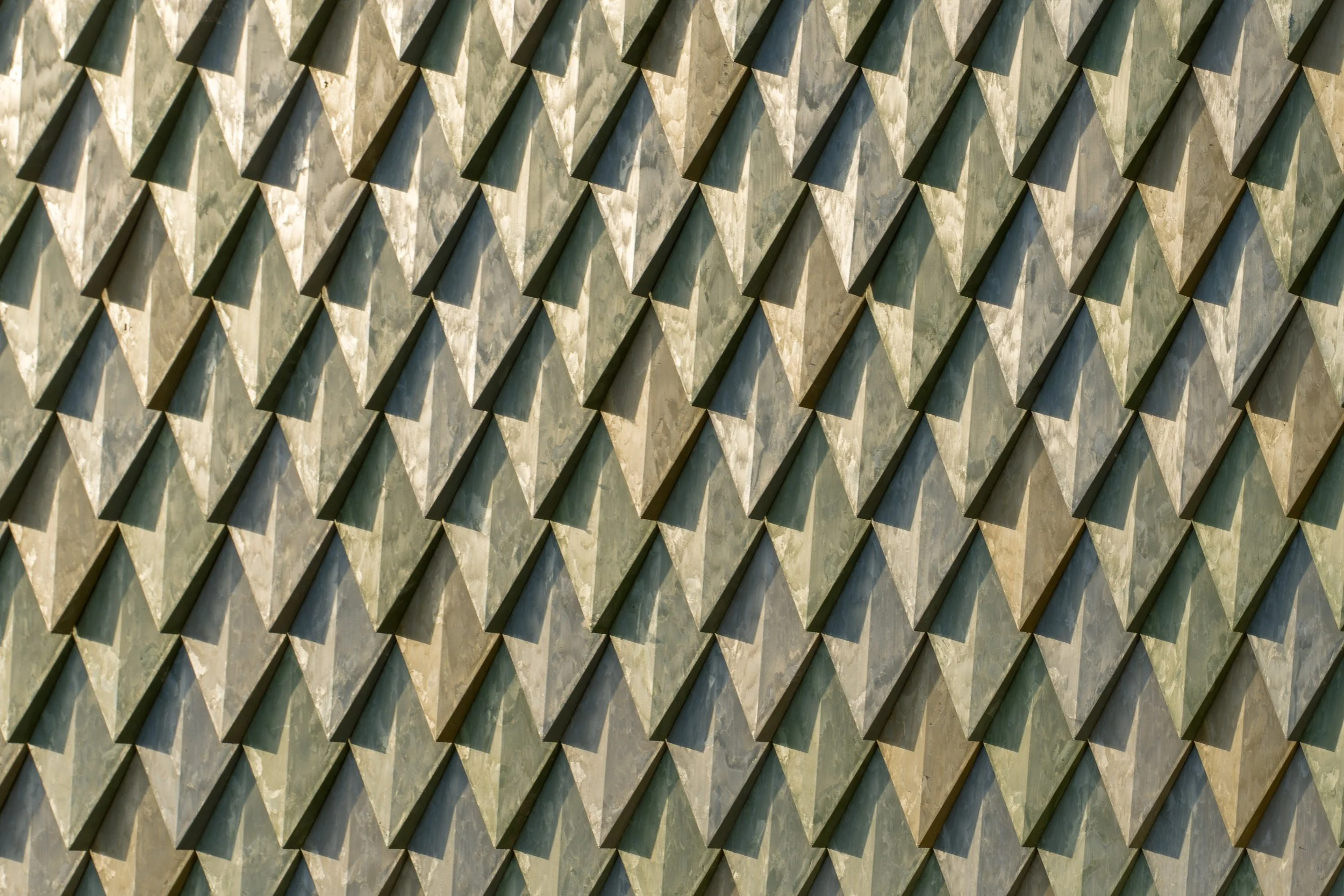 Detail of Pretty Plastic First One tiles at Lensen Centre, Zaltbommel – capturing texture, sunlight and shadow play across the recycled façade.